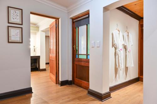 a hallway with a door and two mannequins at Woodall Country House and Spa in Addo