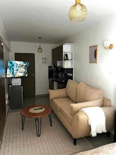 a living room with a couch and a table at Coaral Bells Tsavo in Kiambu