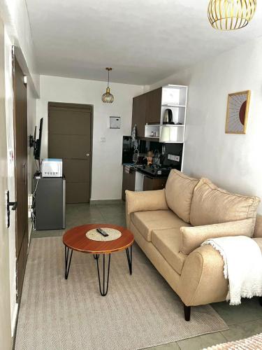 a living room with a couch and a table at Coaral Bells Tsavo in Kiambu