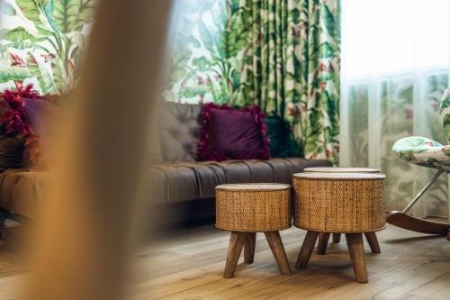 a living room with two stools and a couch at Loom in Bolzano