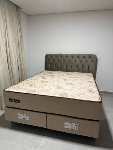 a bed in a room with a large mattress at Condomínio Ouro vilas in Arraial d'Ajuda