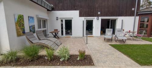 a patio of a house with a bench in the yard at Ahornnest in Bingerbrück