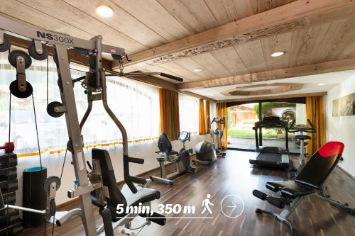 a gym with treadmills and cardio equipment in a room at Sepp & Hannis Suiten im Dorf in Neustift im Stubaital