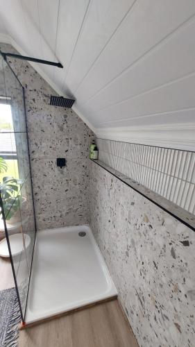a room with a white tub in a room at The Little Lorraine in Gqeberha