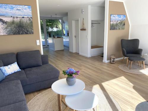 a living room with a couch and a table at Heimathafen Damp, Haus 9 in Damp