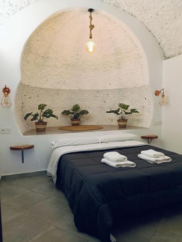 a bedroom with a bed with two towels on it at La Madriguera Eco Caves 3 in Guadix