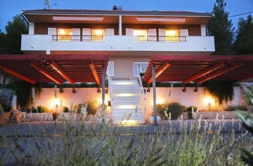 a large house with lights in front of it at Strandnahe Ferienwohnung Mit Terrasse in Podstrana