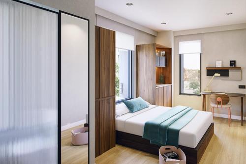 a bedroom with a bed and a desk in it at Lemonade Stays Santiago de Compostela in Santiago de Compostela