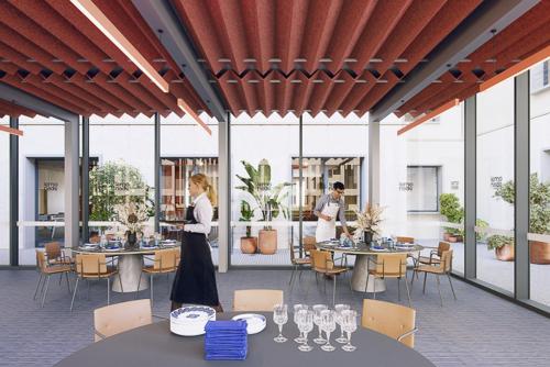 two people standing in a patio with tables and chairs at Lemonade Stays Santiago de Compostela in Santiago de Compostela