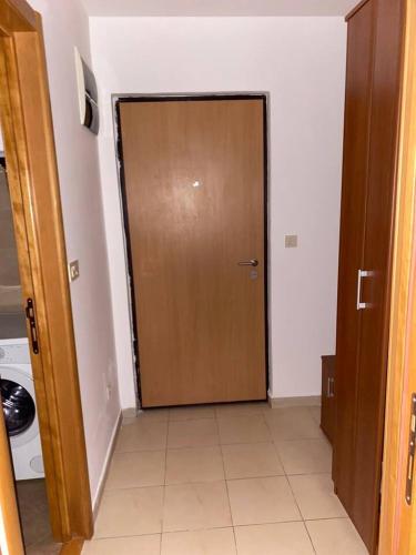 a wooden door in a room with a tile floor at Filip apartment in Podgorica