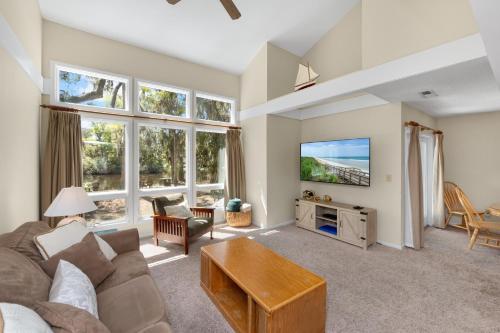 a living room with a couch and a tv at Ocean State of Mind in Edisto Island