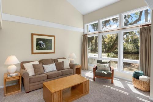 a living room with a couch and a table at Ocean State of Mind in Edisto Island