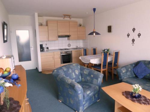 a living room and kitchen with a couch and a table at de ebb in Dorum-Neufeld