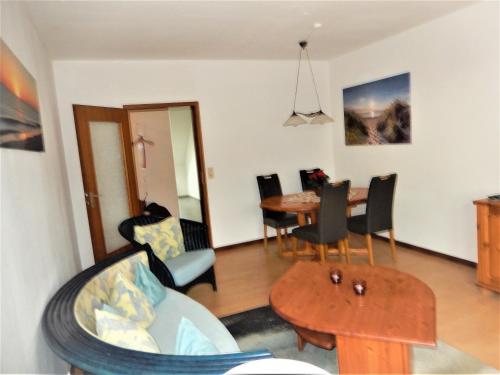 a living room with a table and a dining room at Landhaus Katharina in Westerdeichstrich