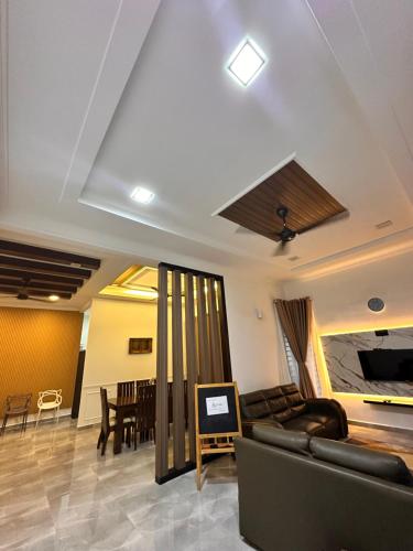 a living room with a couch and a table at Homestay Husna in Dungun