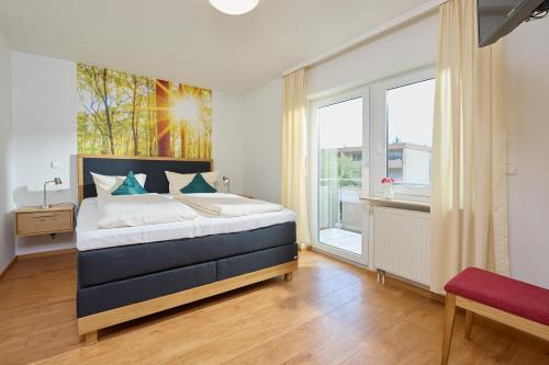 a bedroom with a bed and a large window at Thermen Appartements Gabriela, Appartement 75 qm in Bad Krozingen