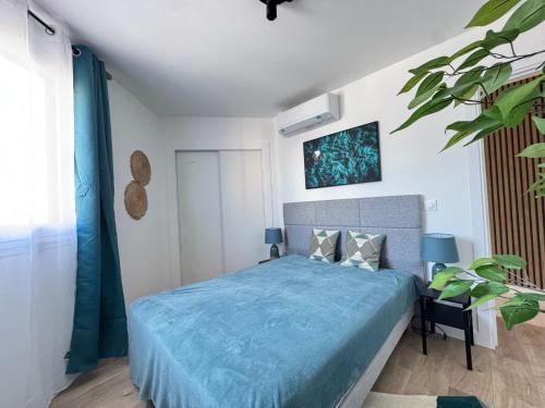 une chambre avec un lit avec une couette bleue dans l'établissement Les Venitiennes, à Cannes