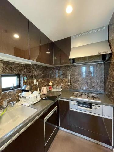 a kitchen with a sink and a stove at Ikebukuro house with 3BR Shinjuku 5min in Tokyo
