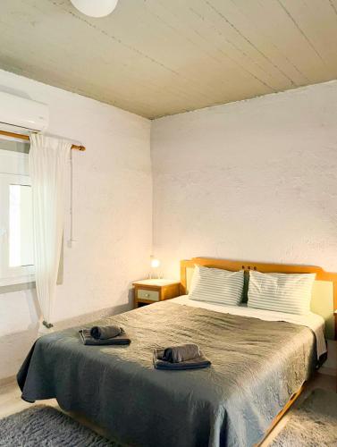 a bedroom with a bed with two towels on it at Marina's Garden Nests - Holiday Bliss Getaways in Romanu