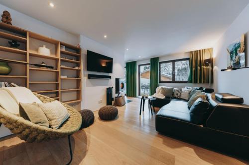 a living room with a couch and a chair at Balma Restaurant Suites in Lech am Arlberg