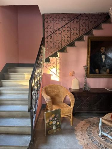 a room with a staircase with a chair and a stair case at Podere la Botte in Lari