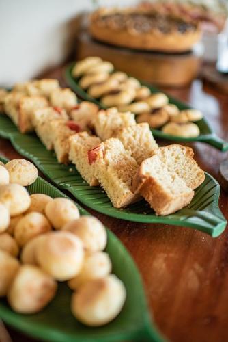 a table with three plates of food on them at Colina Pousada SPA in Fernando de Noronha