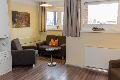 un salon avec deux chaises et un canapé dans l'établissement ancora Marina Haus 1 Nr 02, Typ 2, à Neustadt in Holstein