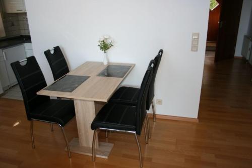 a dining room table with black chairs around it at Haus Lahntalblick in Bad Ems