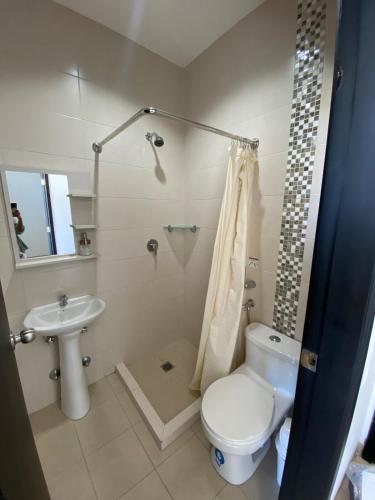 a bathroom with a toilet and a sink at Depa en Salinas en condo privado a una calle del mar con parqueo in Salinas