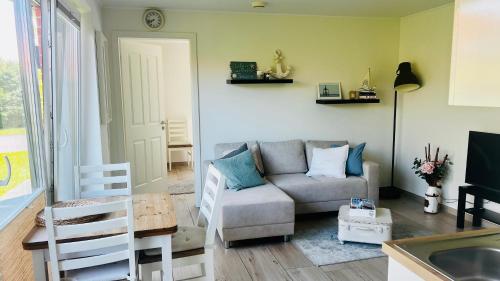 a living room with a couch and a table at Ostbake in Wangerooge