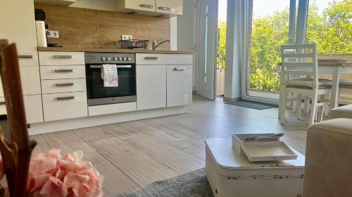 a kitchen with an oven and a table in a room at Ostbake in Wangerooge