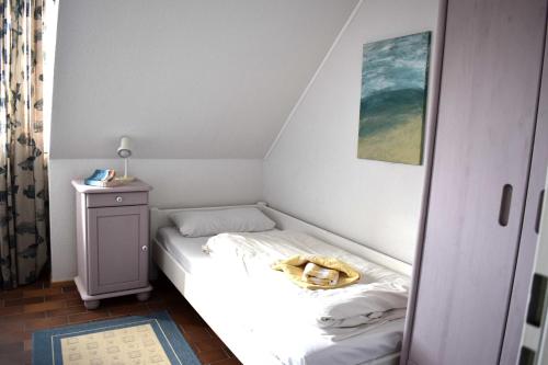 a small bedroom with a bed and a night stand at Resi M5 in Prerow