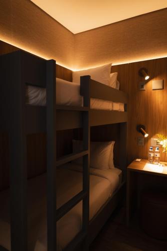 Кровать или кровати в номере W Airport Rooms Fortaleza