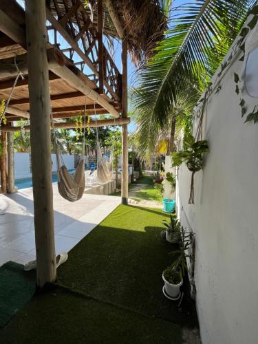 a patio with a hammock and a playground at Paradise BH in Maizal