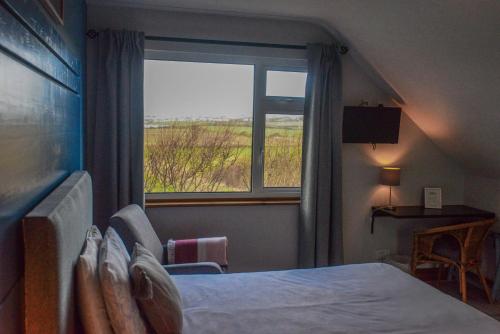 Postel nebo postele na pokoji v ubytování BlueTit Lodge