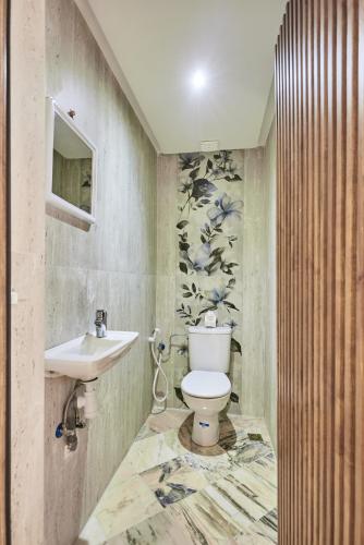a bathroom with a toilet and a sink at Amwaj Apt - Golden Sands and Blue Waves Beach Escape in Mirleft