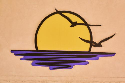 a painting of a ship in the water at Amwaj Apt - Golden Sands and Blue Waves Beach Escape in Mirleft