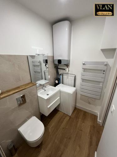 une salle de bain blanche avec des toilettes et un lavabo dans l'établissement Le Voltaire, à Niort