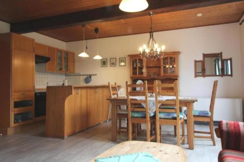 a kitchen and dining room with a table and chairs at Gundi's Ferienhaus in Dorum-Neufeld