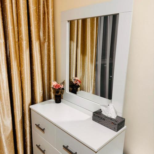 a mirror on top of a dresser in a room at Best place to stay by the sea in Ajman