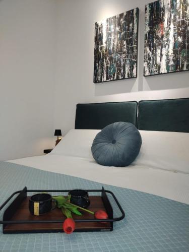 a tray of food on a bed with a blue pillow at Villa Le Chianche in Vico del Gargano