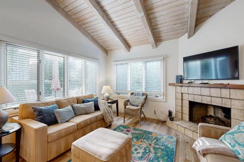 a living room with a couch and a fireplace at Sunny's Santa Barbara Beach House in Santa Barbara