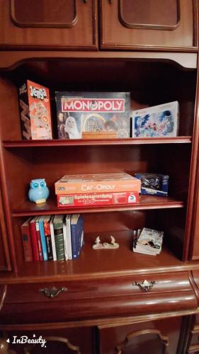 a book shelf with books and other items on it at Beautiful House in Periana, Ideal for hikers in Periana