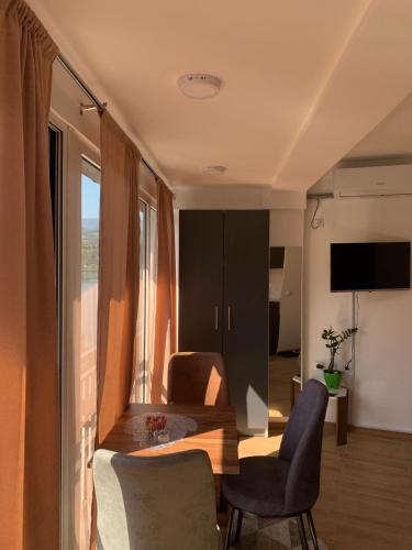 a living room with two chairs and a table and a television at Aluna in Višegrad