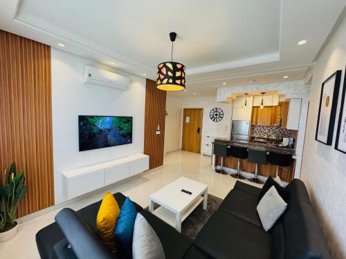a living room with a couch and a kitchen at Modern Apartment in the heart of Tangier in Tangier