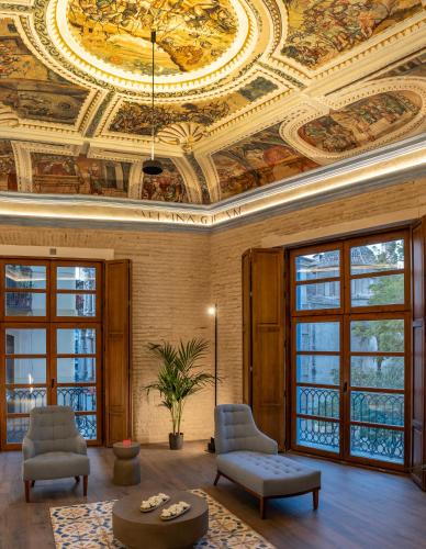 a living room with a ceiling with paintings on it at Axel Hotel Valencia - Adults Only in Valencia