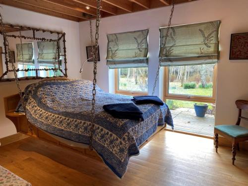 a bedroom with a bed swing in a room at Spacious, cosy 6 bedroom house which sleeps 11 in Banchory