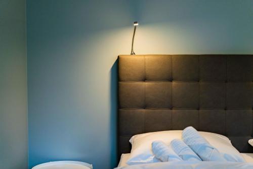a bedroom with a bed with a light above it at Gästehaus "Alte Bücherei" Satrup in Mittelangeln