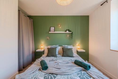 a bedroom with a large bed with green walls at Sweet - Superbe appartement avec parking privé - Paris-Disney & CDG à 25 minutes in Pomponne