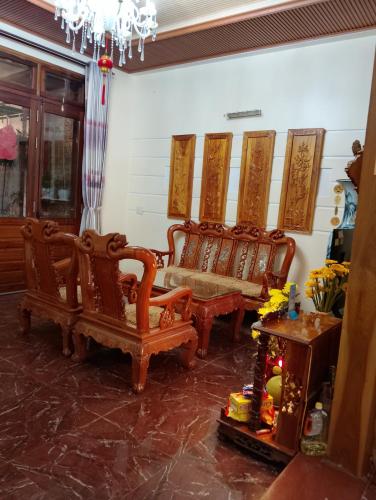 a living room with two chairs and a table at Q HOME Đà Lạt in Da Lat